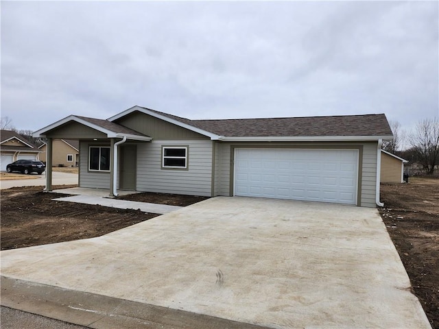 ranch-style house featuring a garage, concrete driveway, and roof with shingles