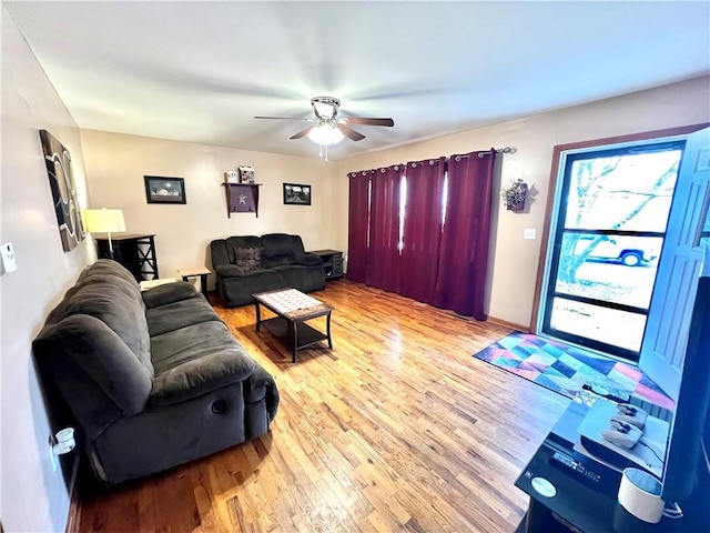 living room with light wood-style flooring and ceiling fan