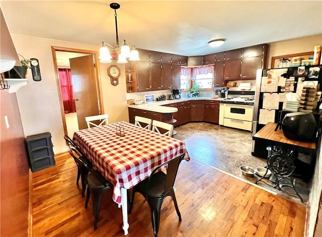 dining area featuring a chandelier and wood finished floors