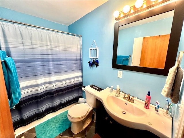 full bath featuring curtained shower, tile patterned flooring, vanity, and toilet