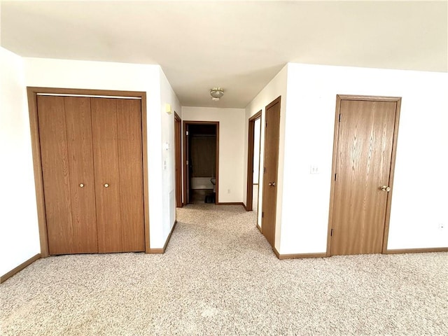 unfurnished bedroom with carpet and baseboards