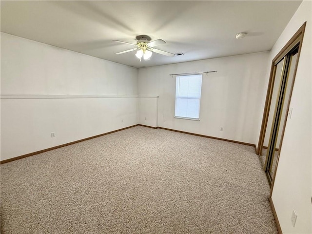 unfurnished bedroom featuring a ceiling fan, a closet, light carpet, and baseboards