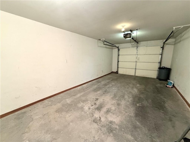 garage with baseboards and a garage door opener