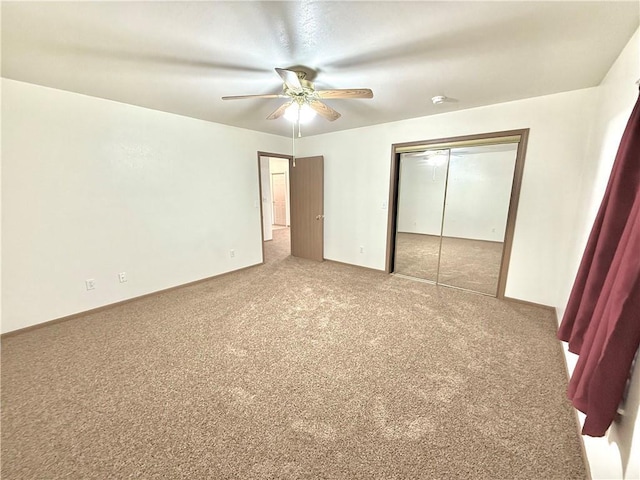 unfurnished bedroom with carpet floors, a closet, and a ceiling fan