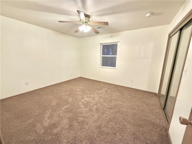 unfurnished bedroom with carpet, a closet, visible vents, a ceiling fan, and baseboards