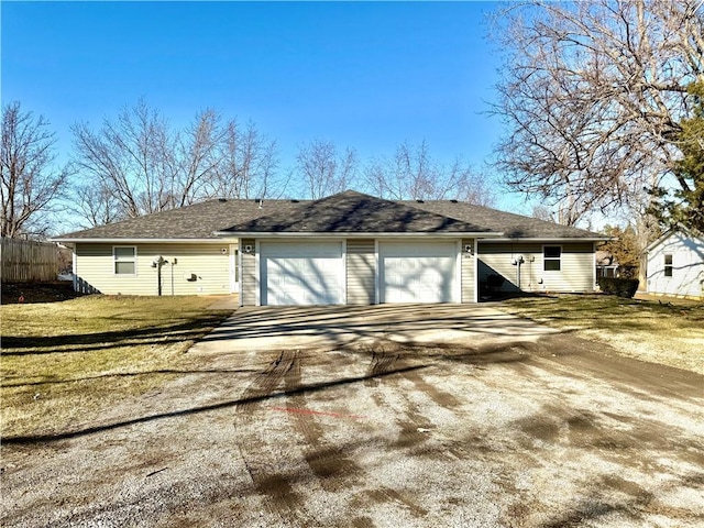 view of home's exterior featuring driveway, an attached garage, fence, and a yard