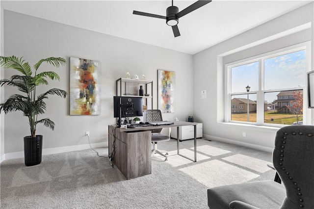 office area featuring a ceiling fan, baseboards, and carpet floors