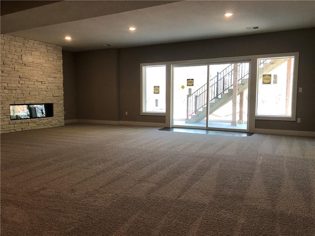 unfurnished living room featuring baseboards, recessed lighting, visible vents, and carpet