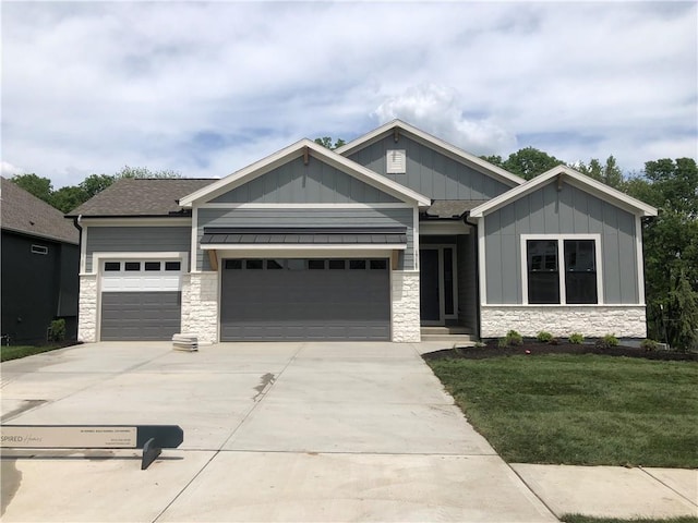 craftsman house with driveway, an attached garage, stone siding, and board and batten siding
