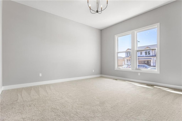 17147 S Heatherwood St, Olathe, KS 66062 - spare room featuring a chandelier, baseboards, and carpet floors