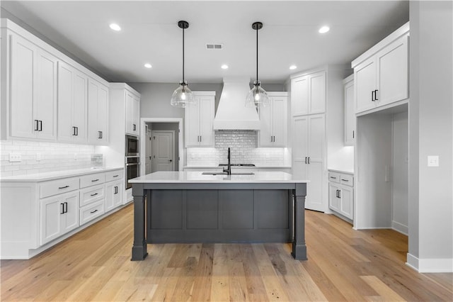 17147 S Heatherwood St, Olathe, KS 66062 - kitchen with custom range hood, stainless steel appliances, tasteful backsplash, white cabinetry, and recessed lighting