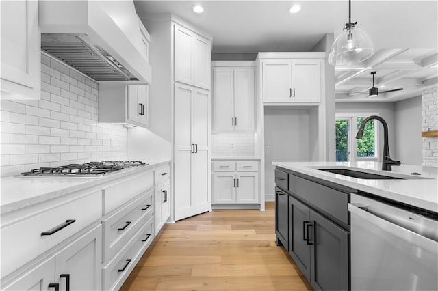 17147 S Heatherwood St, Olathe, KS 66062 - kitchen featuring dishwasher, custom exhaust hood, white cabinetry, coffered ceiling, and a sink