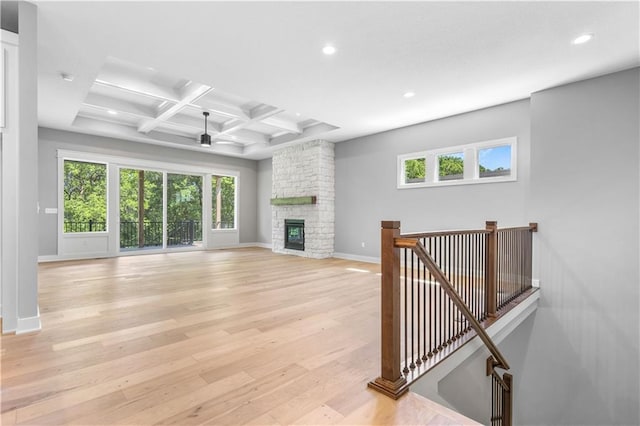 17147 S Heatherwood St, Olathe, KS 66062 - unfurnished living room with beamed ceiling, light wood finished floors, healthy amount of natural light, baseboards, and recessed lighting