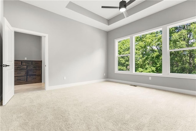 17147 S Heatherwood St, Olathe, KS 66062 - unfurnished room featuring carpet, baseboards, ceiling fan, and a tray ceiling