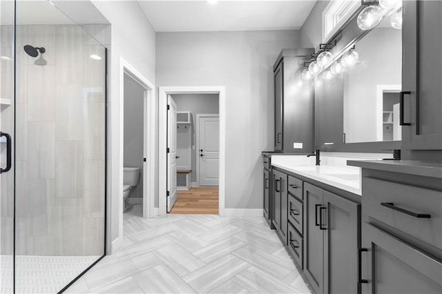 17147 S Heatherwood St, Olathe, KS 66062 - bathroom featuring toilet, double vanity, a stall shower, and baseboards