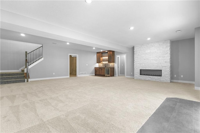 17147 S Heatherwood St, Olathe, KS 66062 - unfurnished living room featuring recessed lighting, light colored carpet, stairway, baseboards, and bar