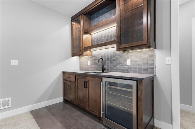 17147 S Heatherwood St, Olathe, KS 66062 - bar area with a sink, beverage cooler, baseboards, and tasteful backsplash