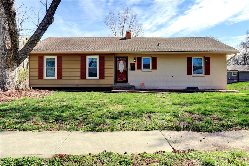 13106 E 49th St S, Independence, MO 64055 - single story home with brick siding, entry steps, a front lawn, and a chimney