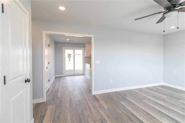 unfurnished room with a ceiling fan, recessed lighting, baseboards, and light wood finished floors