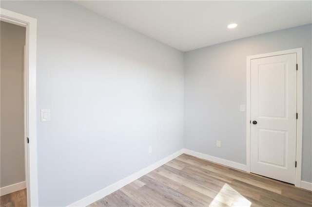 empty room with light wood finished floors and baseboards