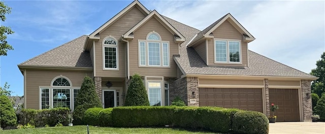 15498 Cedar Ln, Basehor, KS 66007 - view of front of house with brick siding, concrete driveway, roof with shingles, and an attached garage