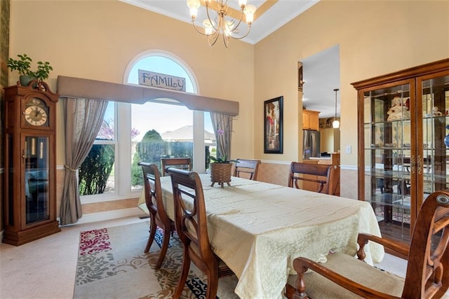 15498 Cedar Ln, Basehor, KS 66007 - carpeted dining room featuring ornamental molding, a chandelier, and a high ceiling