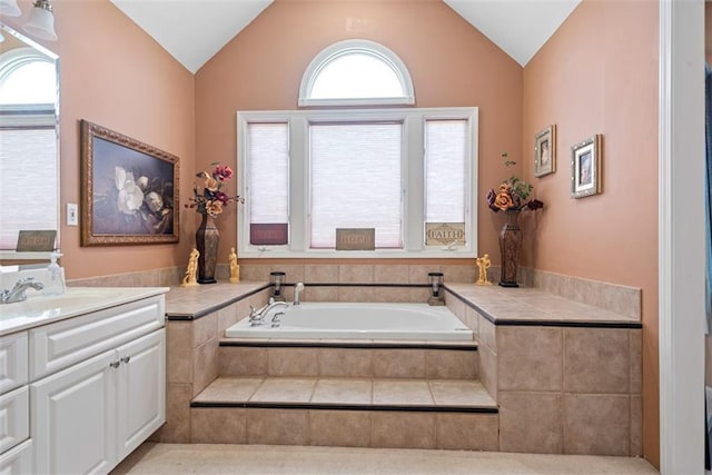 15498 Cedar Ln, Basehor, KS 66007 - bathroom with vanity, a bath, and vaulted ceiling