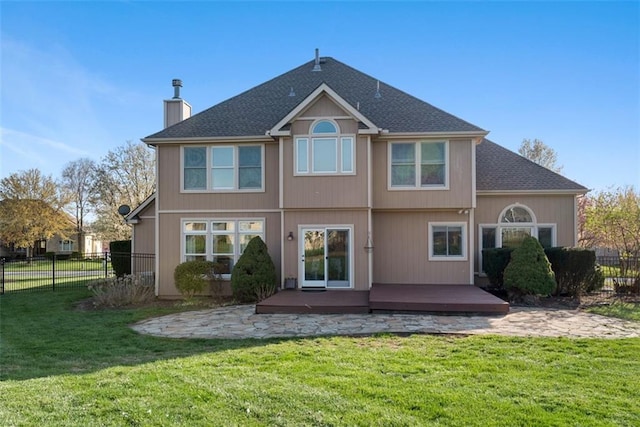 15498 Cedar Ln, Basehor, KS 66007 - rear view of house featuring a wooden deck, a chimney, roof with shingles, and a patio area