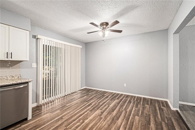 interior space featuring ceiling fan, dark wood-style flooring, and a textured wall