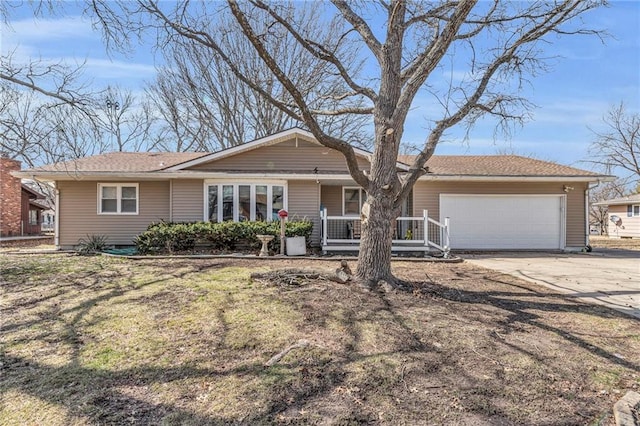 single story home with a garage, driveway, and a porch