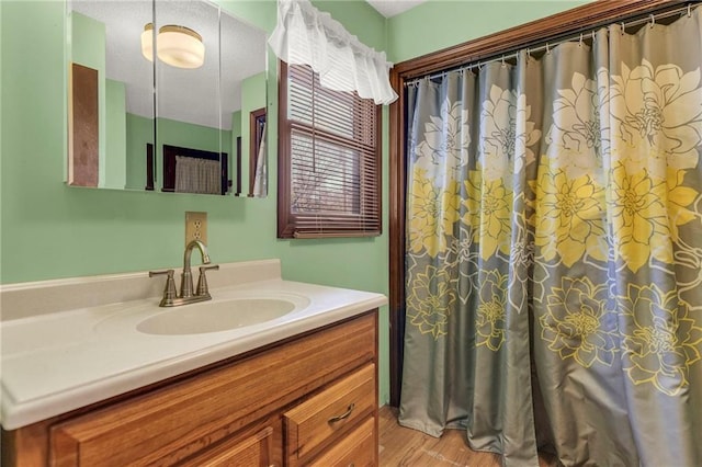 bathroom featuring vanity and wood finished floors