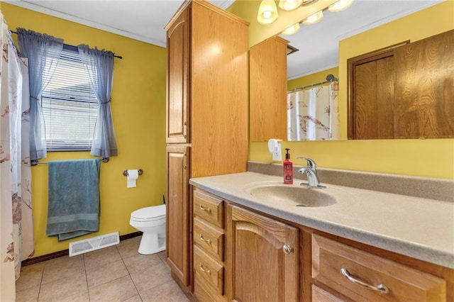 bathroom featuring tile patterned floors, visible vents, crown molding, and vanity