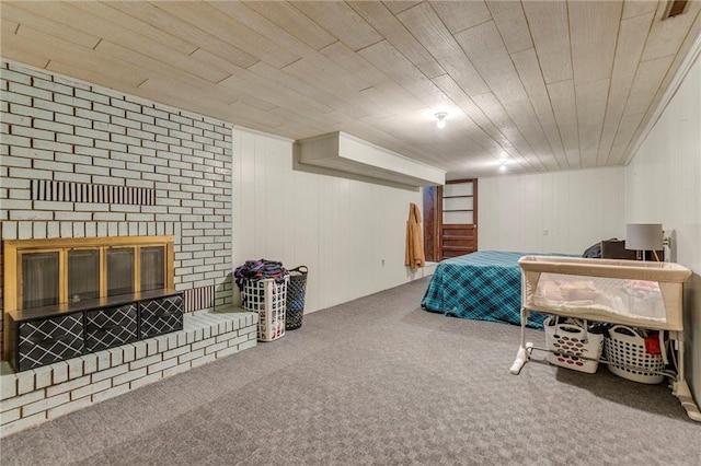 carpeted bedroom with wood ceiling and a brick fireplace