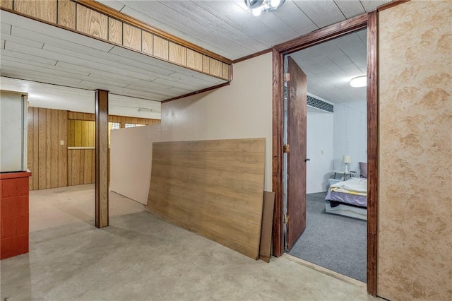 finished basement featuring wood walls and carpet flooring