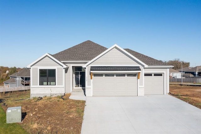 view of front facade featuring driveway, a garage, fence, and roof with shingles