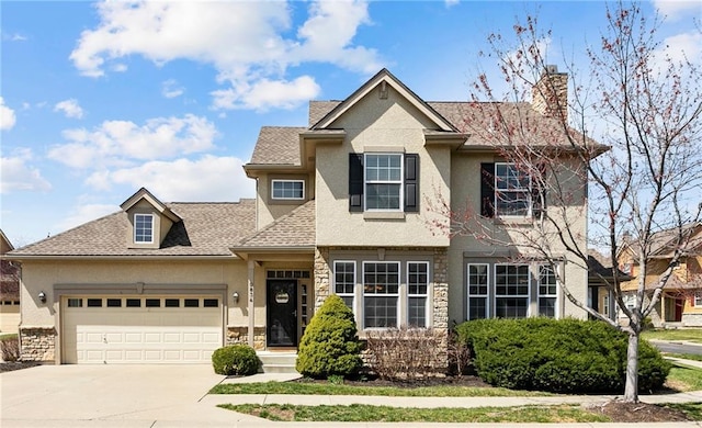 traditional home featuring stucco siding, concrete driveway, an attached garage, and a shingled roof