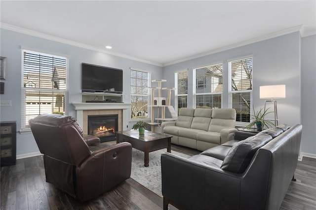 living room featuring a wealth of natural light, dark wood-style floors, and a tile fireplace