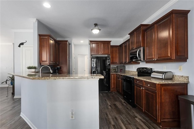 kitchen with dark wood finished floors, a peninsula, black appliances, and light stone counters