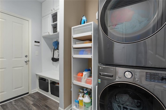 laundry room with stacked washer and dryer and dark wood-style floors