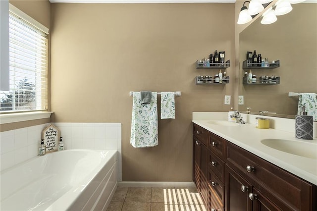 full bathroom featuring tile patterned flooring, baseboards, double vanity, a bath, and a sink