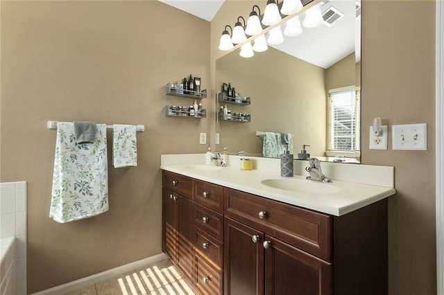 bathroom featuring double vanity, visible vents, baseboards, and a sink