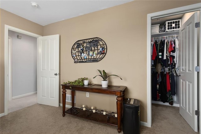 corridor with baseboards and carpet