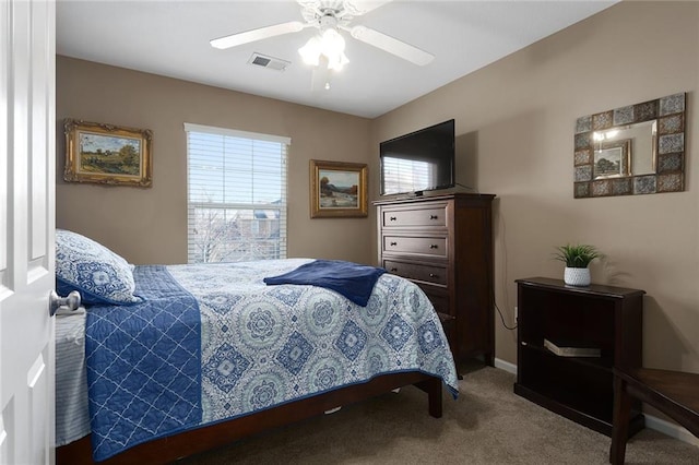 carpeted bedroom featuring visible vents and ceiling fan