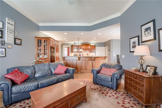 living area with recessed lighting, a textured ceiling, and crown molding