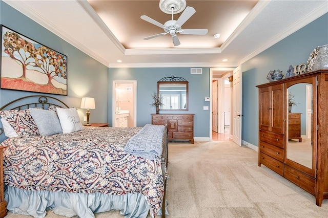 bedroom featuring visible vents, carpet floors, baseboards, a tray ceiling, and crown molding