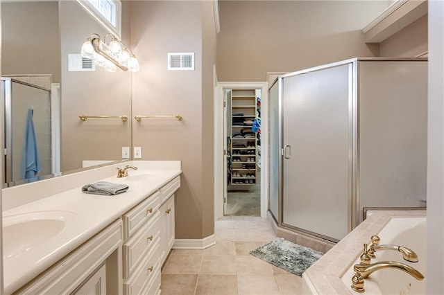 bathroom with tile patterned flooring, visible vents, a shower stall, a spacious closet, and a sink