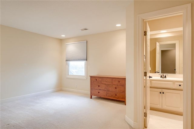 unfurnished bedroom with baseboards, visible vents, recessed lighting, light carpet, and connected bathroom