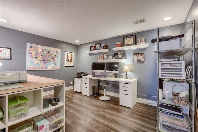 office area featuring visible vents, baseboards, recessed lighting, wood finished floors, and a textured ceiling