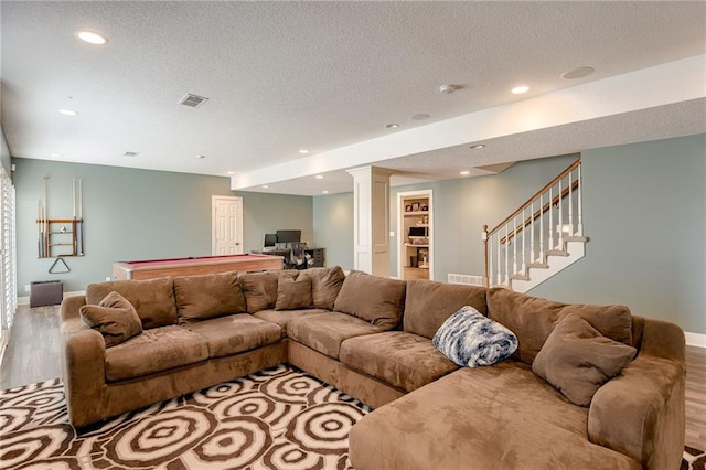 living area featuring visible vents, recessed lighting, a textured ceiling, and wood finished floors