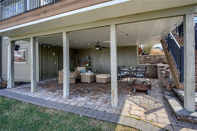 view of patio with an outdoor fire pit and ceiling fan